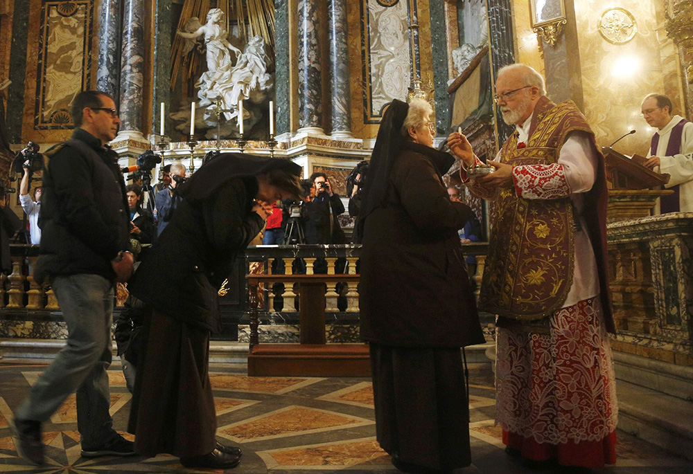 Cardinal Sean O'Malley of Boston gives Communion as he celebrates Mass at his titular church, Santa Maria della Vittoria, March 10, 2013, in Rome. (CNS/Reuters/Chris Helgren)