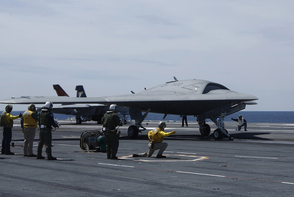 Crew members prepare May 14, 2013, to launch an X-47B pilot-less drone combat aircraft for the first time off an aircraft carrier, the USS George H. W. Bush in the Atlantic Ocean off the coast of Virginia. (CNS/Reuters/Jason Reed)