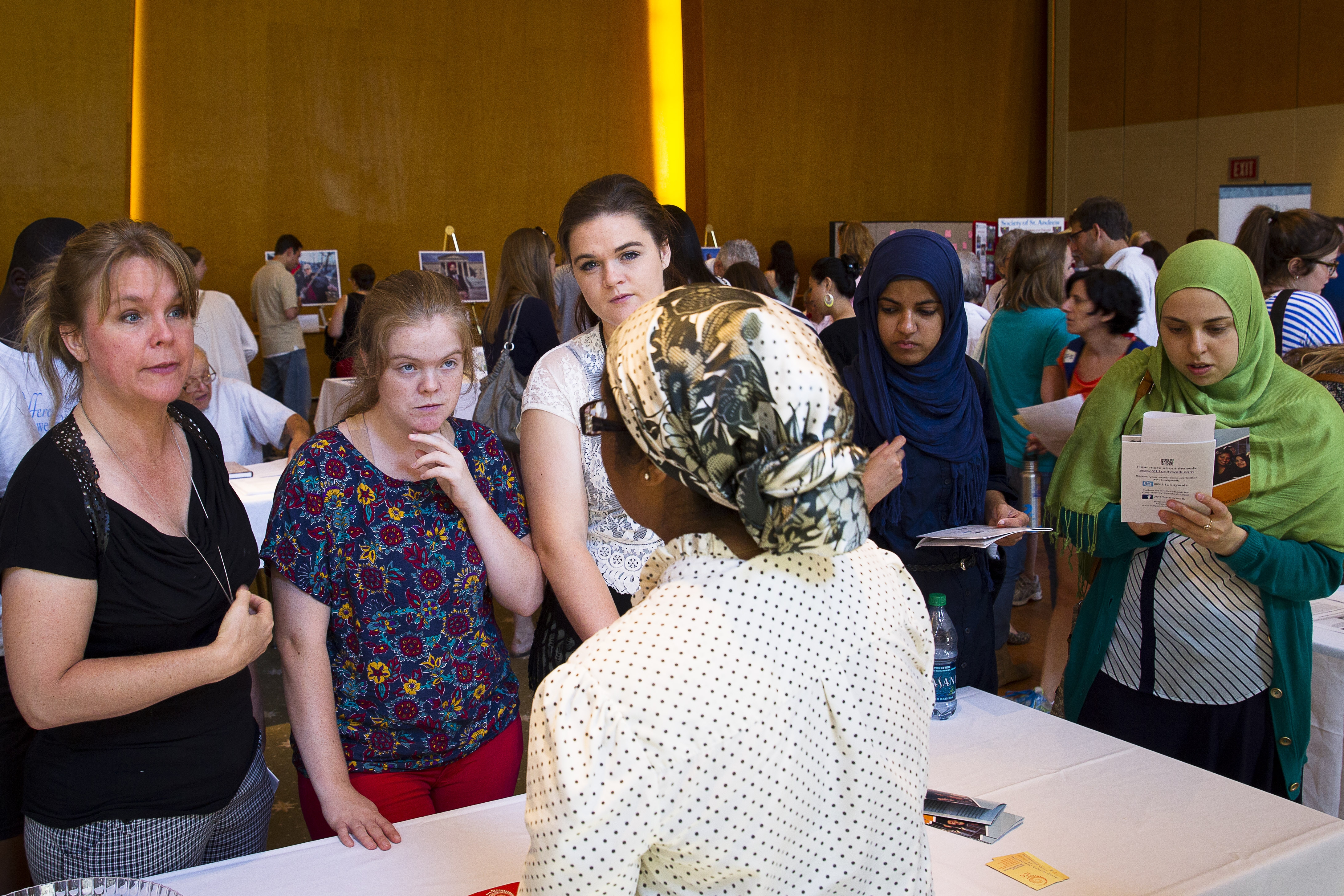 Women of different faiths get information about other religions during the annual Unity Walk Sept. 21, 2014, in Washington. (CNS/Tyler Orburn)