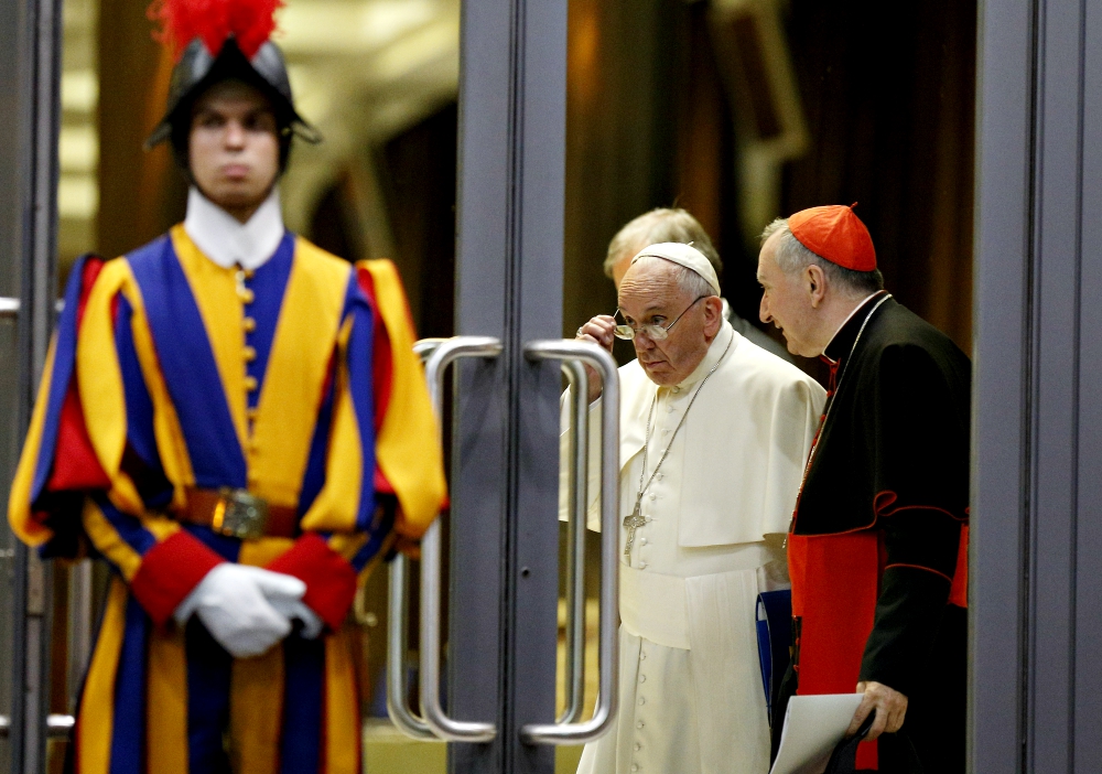 Pope Francis and Cardinal Pietro Parolin, Vatican secretary of state, talk as they leave the opening session of the Synod of Bishops on the family at the Vatican Oct. 5, 2015. (CNS/Paul Haring)