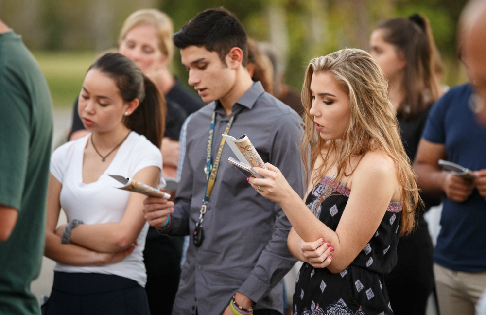 Parishioners of Mary Help of Christians Church in Parkland, Florida, pray during an outdoor Stations of the Cross service Feb. 16 dedicated to the victims and survivors of the deadly mass shooting at nearby Marjory Stoneman Douglas High School. (CNS)