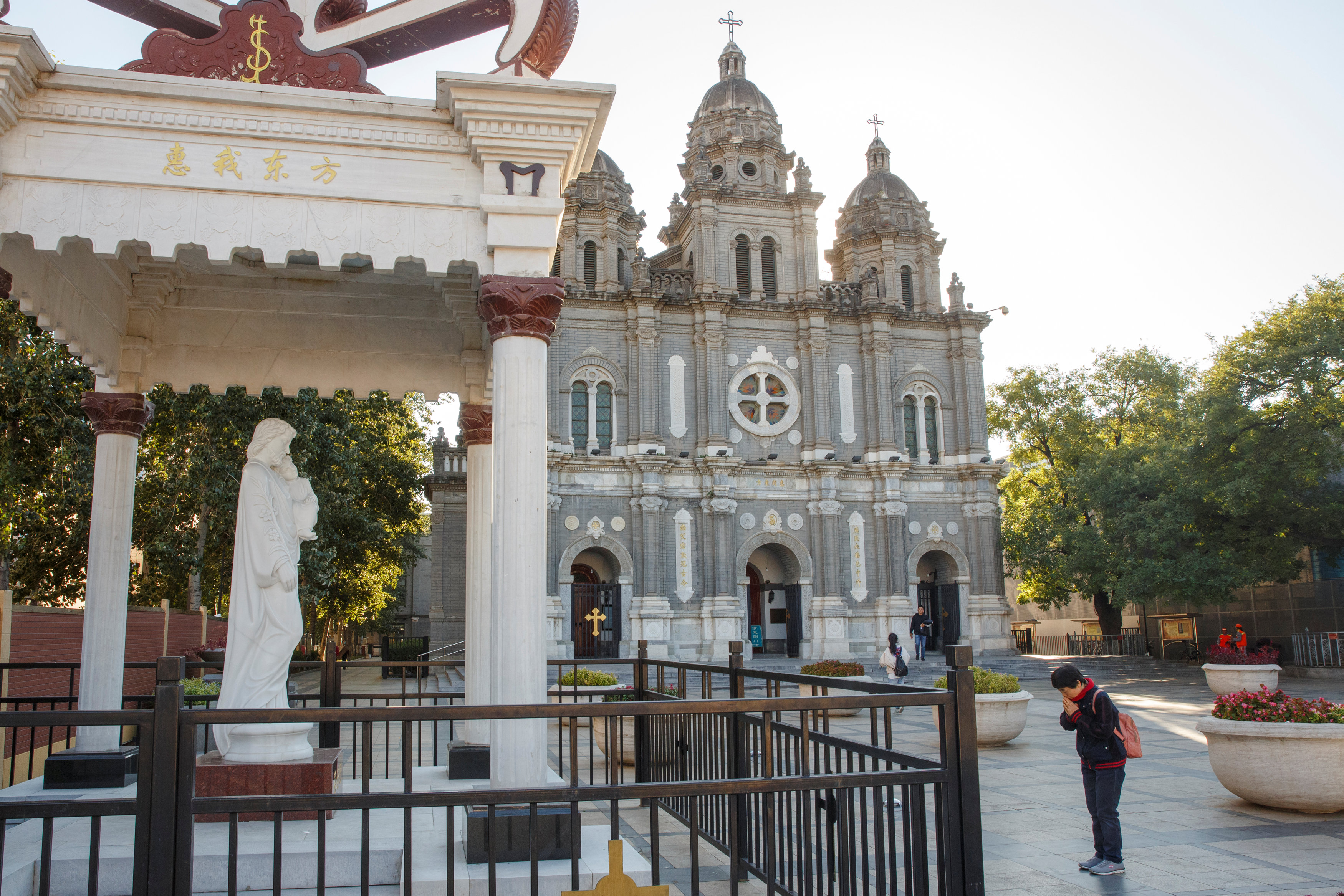 A woman prays Oct. 1 outside St. Joseph Catholic Church in Beijing. (CNS/Isaac Brekken, EPA)