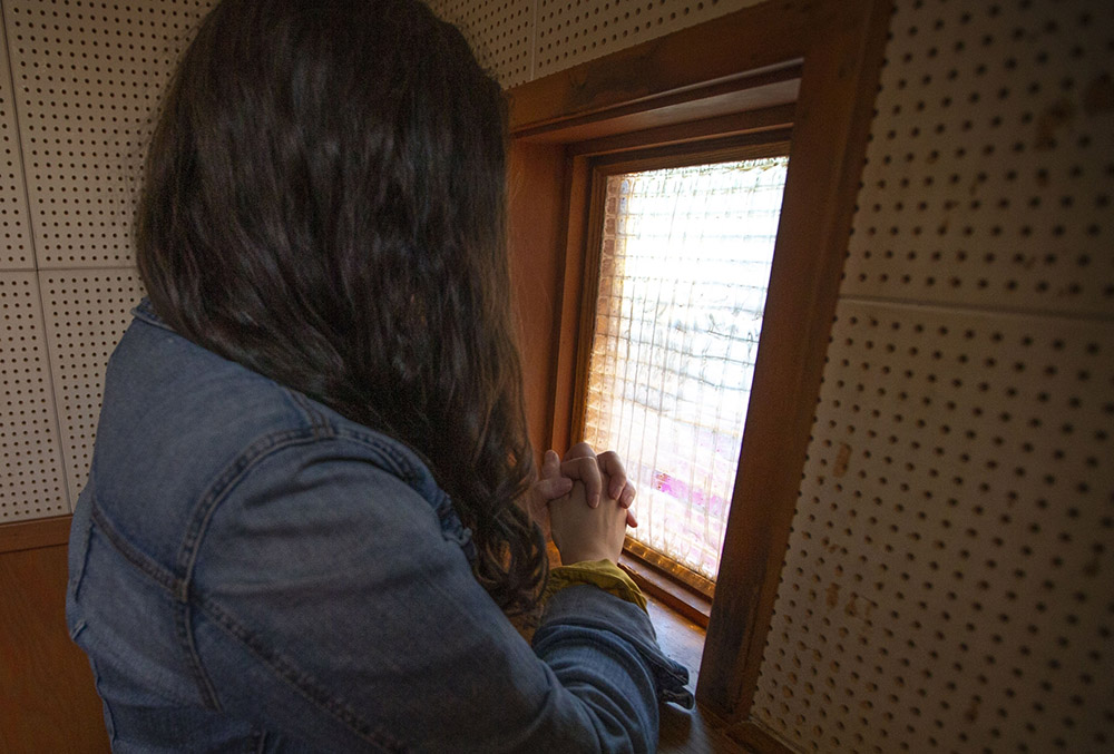 A woman offers her confession to a priest in California in a 2019 file photo. (CNS/Chaz Muth)