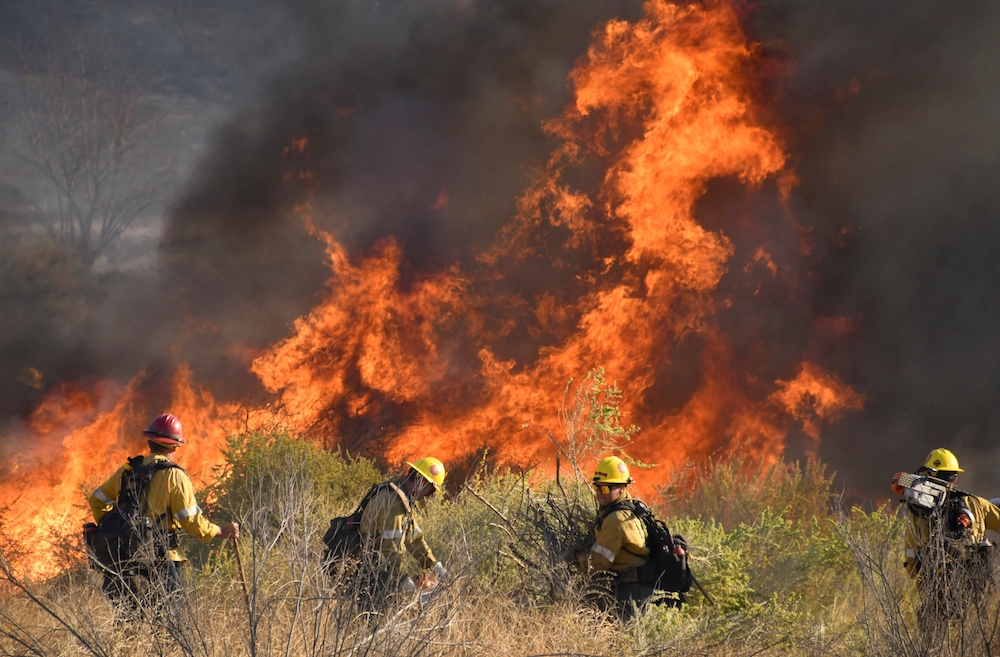 Firefighters battle a wind-driven wildfire in Canyon Country near Los Angeles in October 2019. (CNS photo/Gene Blevins, Reuters)