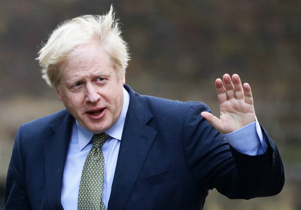 British Prime Minister Boris Johnson waves after meeting with Queen Elizabeth in London to ask for permission to form a government Dec. 13. (CNS/Reuters/Lisi Niesner)