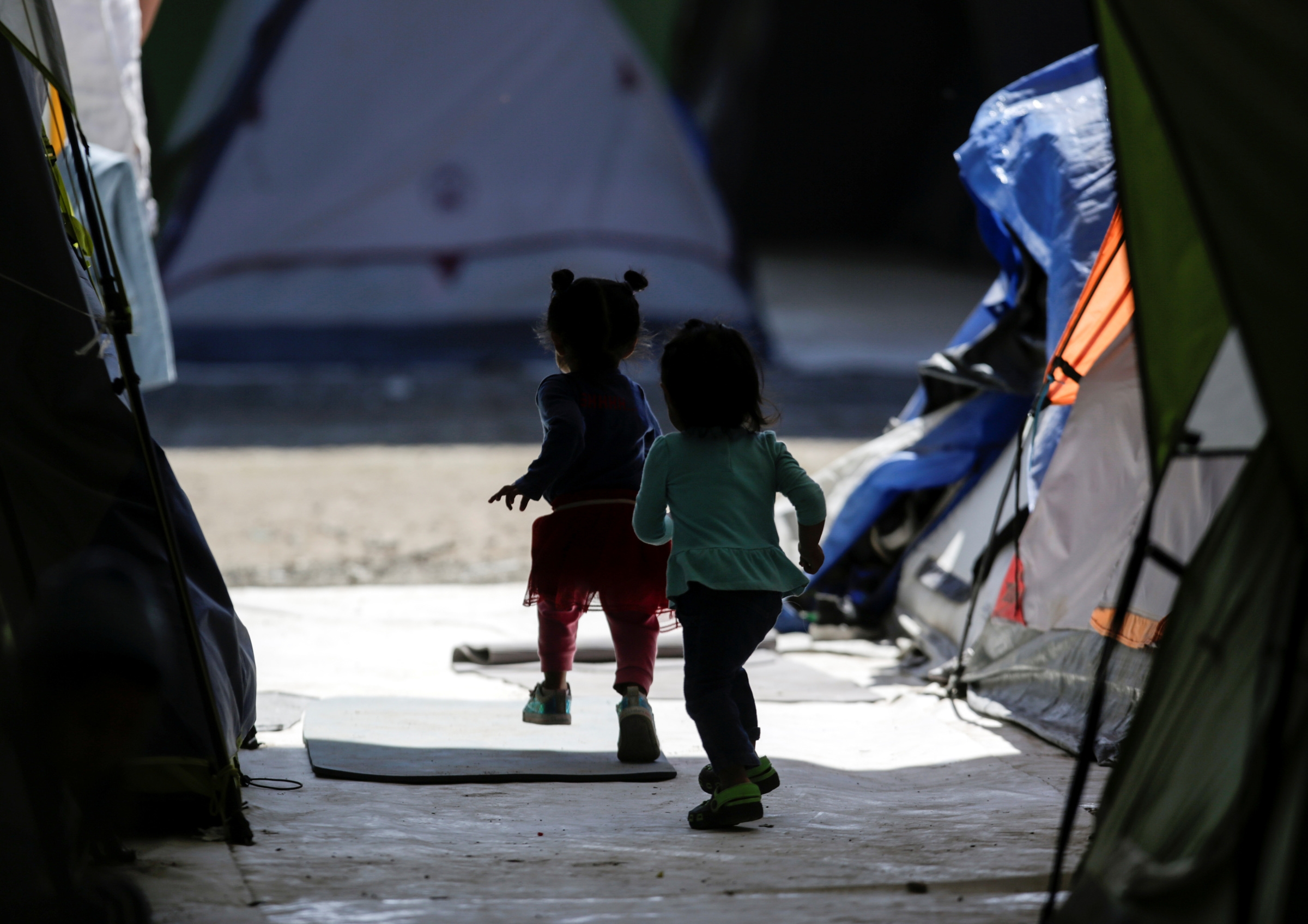 Migrant girls, who are asylum-seekers sent back to Mexico from the U.S. under the Trump administration's "Remain in Mexico" policy, are seen playing at a provisional campsite near the Rio Bravo in Matamoros, Mexico, Feb. 27, 2020. (CNS photo/Daniel Becerr