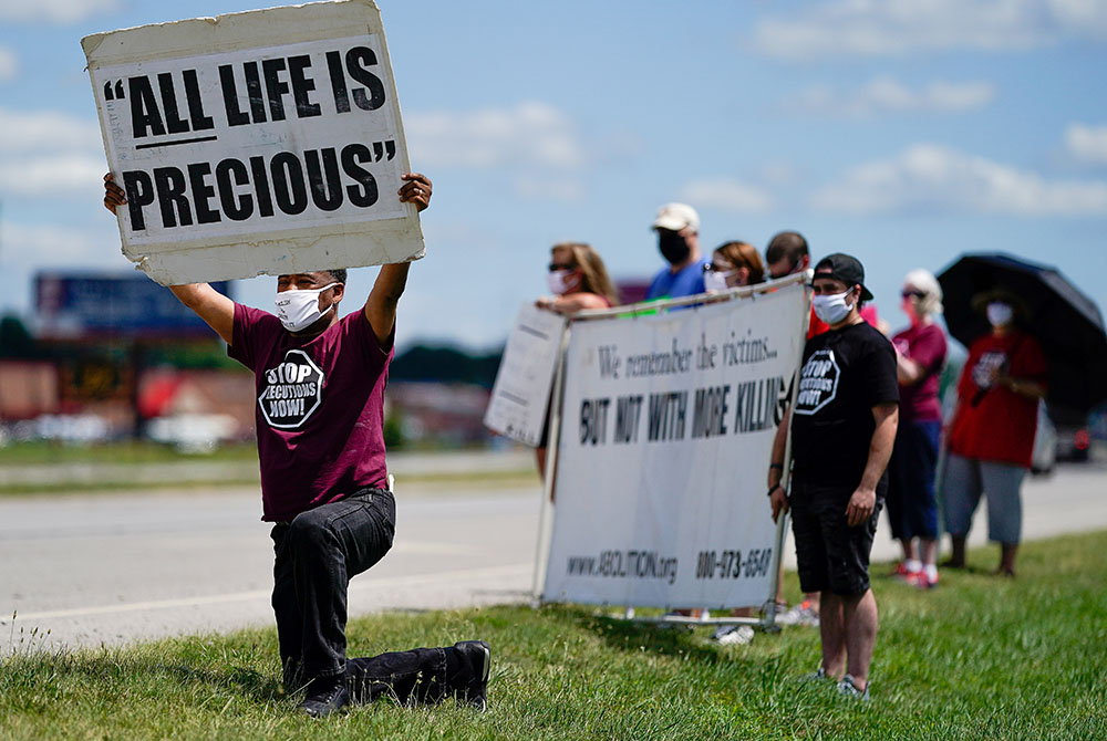 Demonstrators are seen near the Federal Correctional Complex in Terre Haute, Indiana, to show their opposition to the death penalty July 13, 2020. (CNS/Bryan Woolston, Reuters)