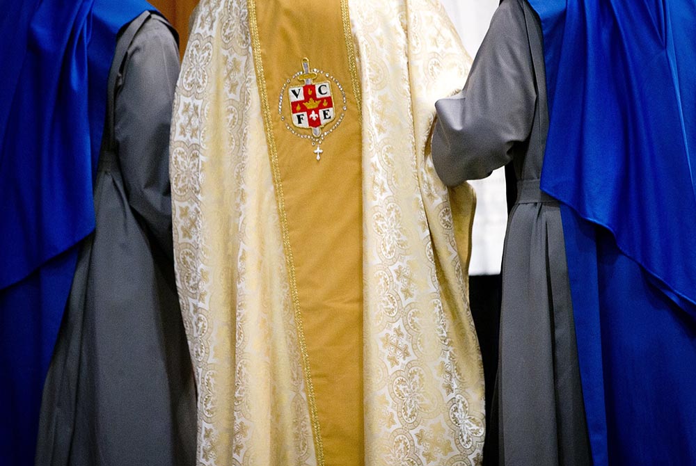 Sisters of the Servants of the Lord and the Virgin of Matara help then-Cardinal Theodore McCarrick walk through Holy Comforter-St. Cyprian Catholic Church in Washington after the ceremony for their profession of vows Nov. 1, 2017, in Washington. (CNS/Tyle