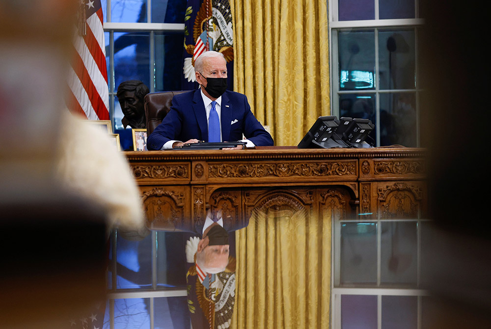 President Joe Biden signs executive orders at the White House Feb. 2 in Washington. (CNS/Tom Brenner, Reuters)