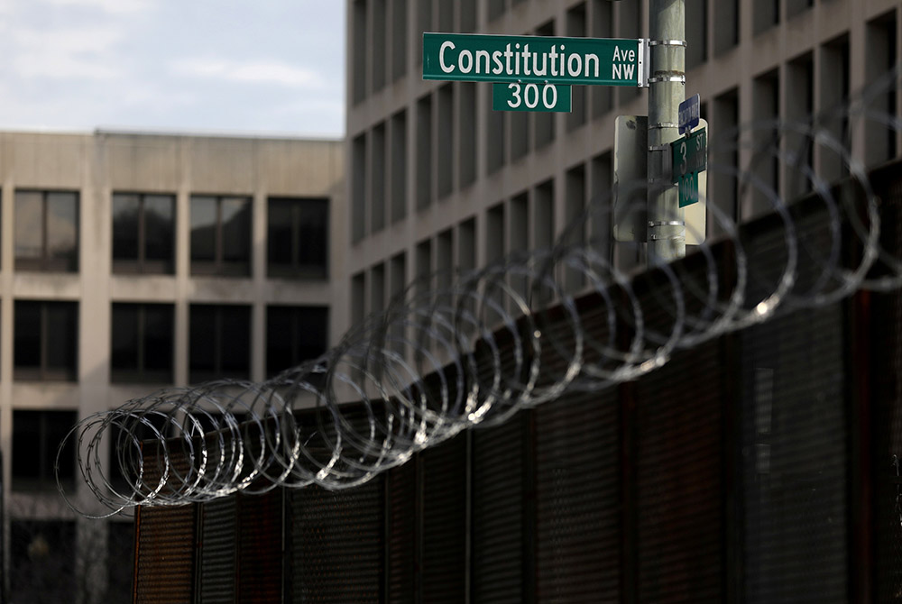 Fencing topped with razor wire surrounds buildings on Capitol Hill in Washington Feb. 9, the first day of the second impeachment trial of former President Donald Trump. (CNS/Leah Millis, Reuters)