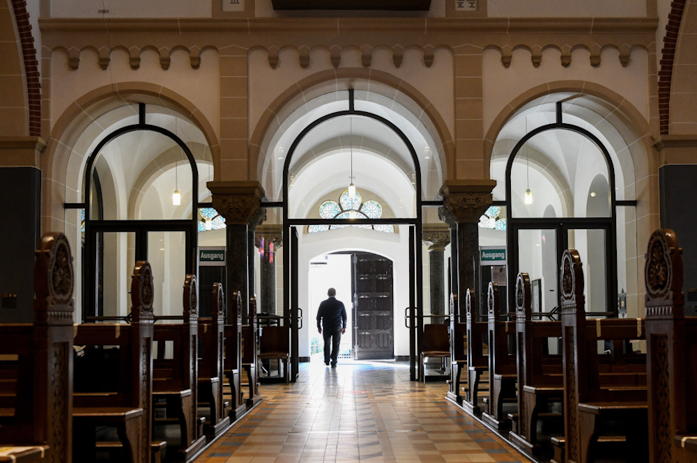 A man leaves an empty church in Bonn, Germany, June 12, 2020. (CNS/KNA/Harald Oppitz)