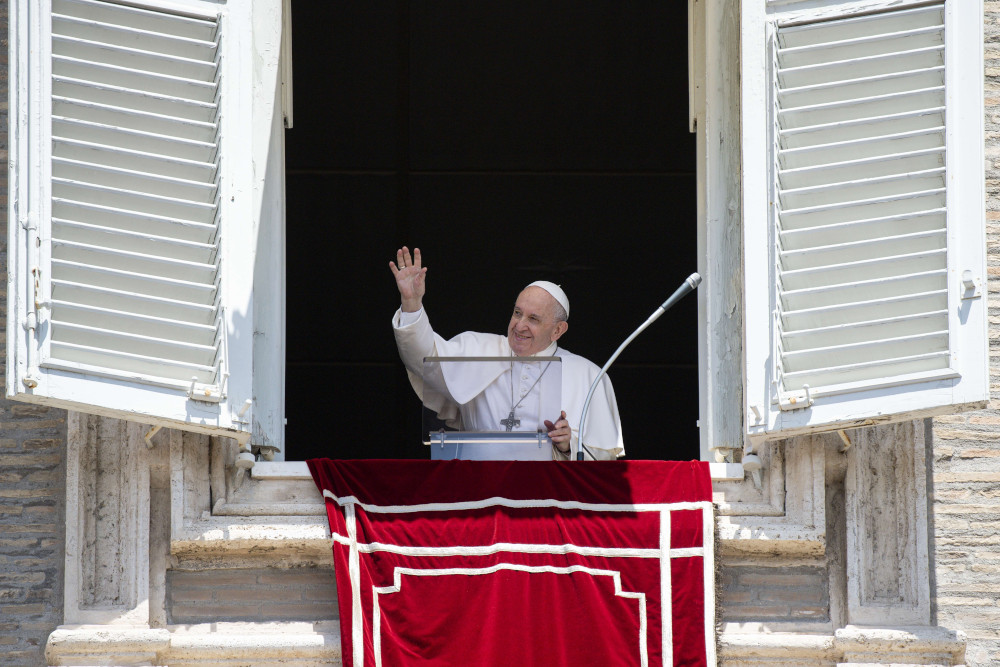 Pope Francis greets the crowd as he leads the Angelus from the window of his studio overlooking St. Peter's Square at the Vatican June 28. (CNS/Vatican Media)