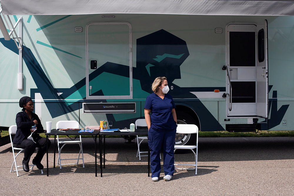 Nurses in Detroit wait for people to come by to receive their COVID-19 vaccine at a mobile pop-up vaccination clinic hosted by the Detroit Health Department with the Detroit Public Schools Community District July 21. (CNS/Reuters/Emily Elconin)