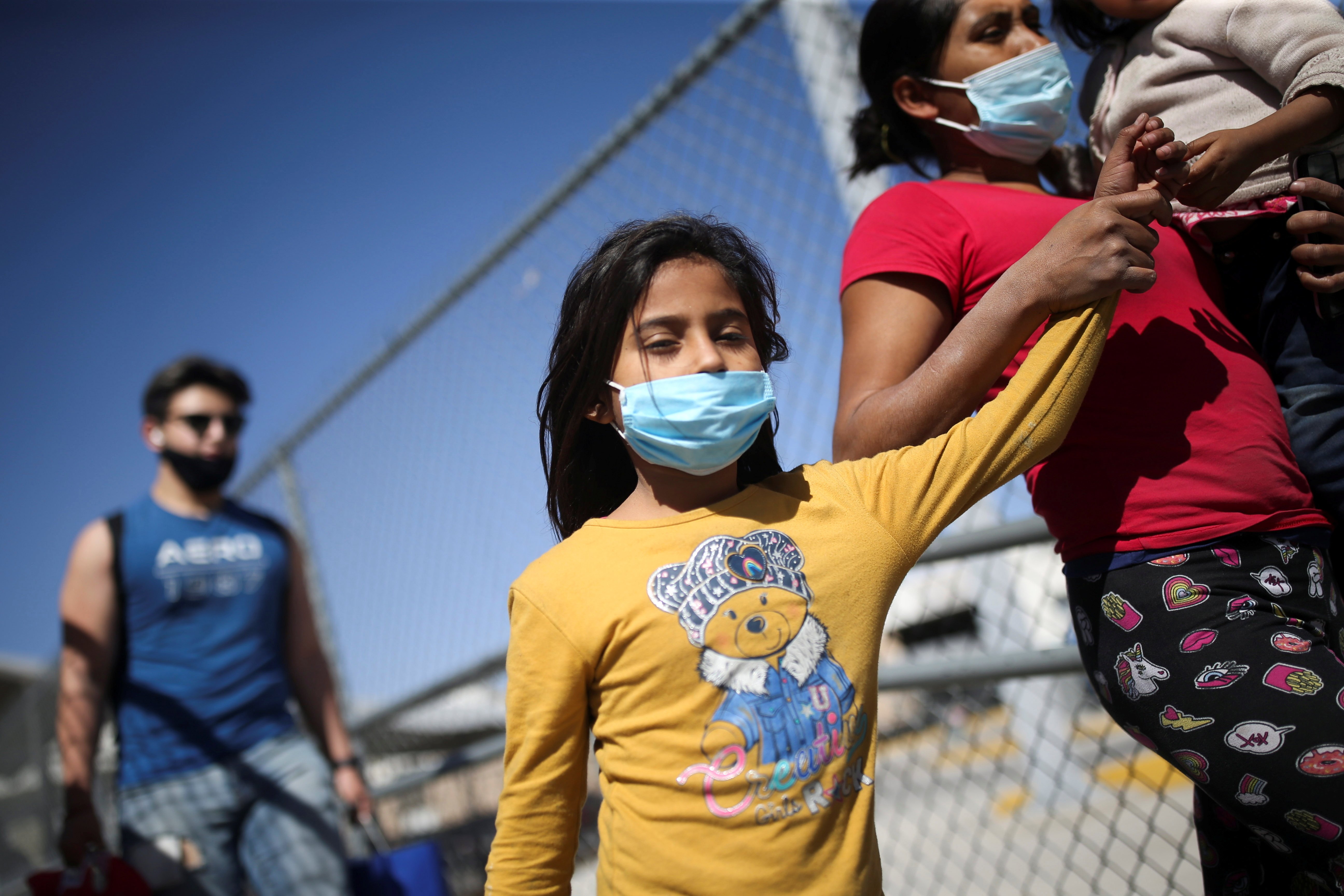 Asylum-seeking migrants from Central America who were deported from the U.S walk near the Lerdo Stanton international border bridge in Ciudad Juarez, Mexico, March 30, 2021. (CNS photo/Edgard Garrido, Reuters)