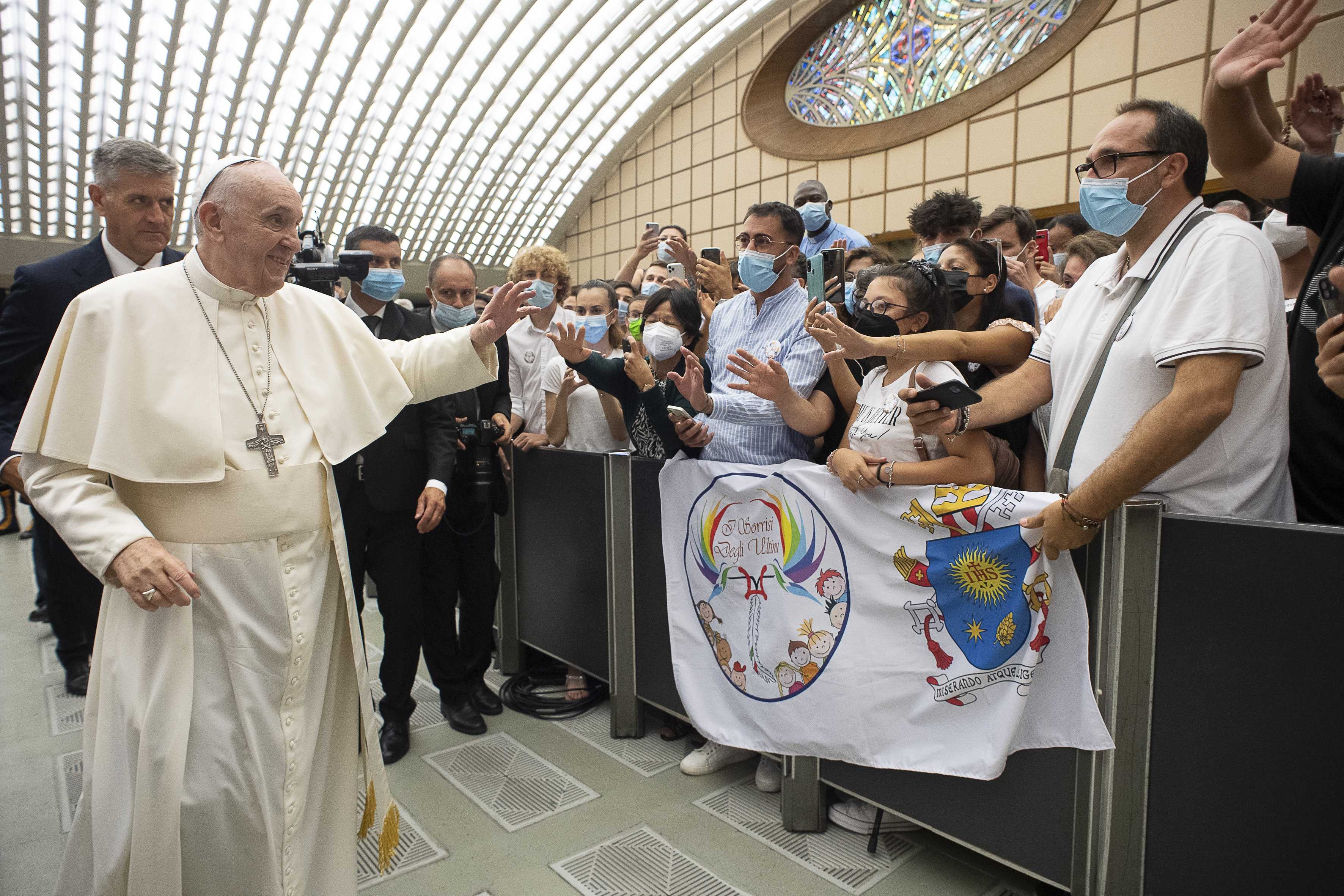 Pope Francis greets the crowd during his general audience in Paul VI hall at the Vatican Aug. 4, 2021. It was his first audience since undergoing colon surgery July 4. (CNS photo/Vatican Media)