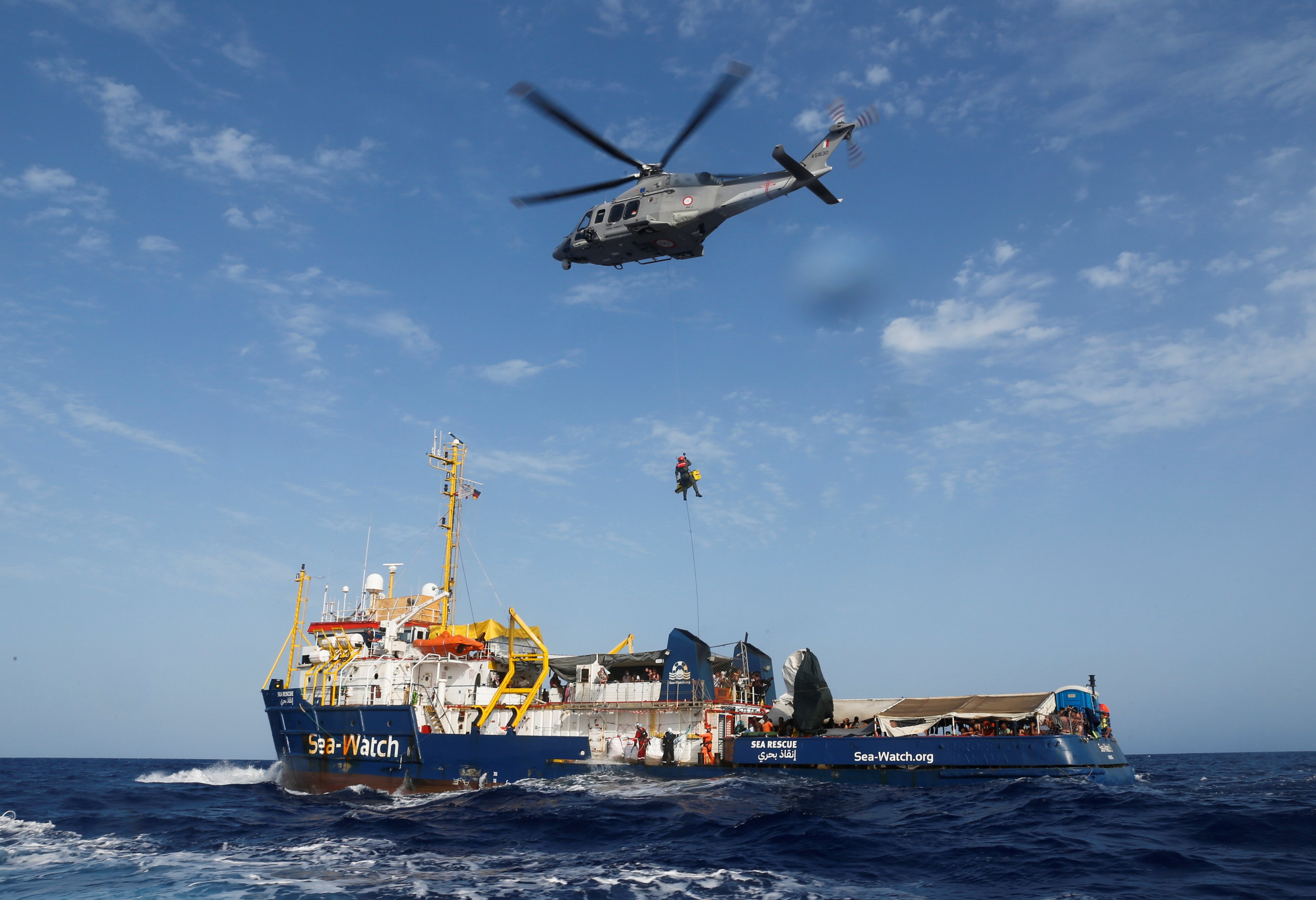 An Armed Forces of Malta helicopter medically evacuates a critically ill Libyan boy and his family from the German NGO migrant rescue ship Sea-Watch 3 in the western Mediterranean Sea Aug. 2, 2021. (CNS photo/Darrin Zammit Lupi, Reuters)