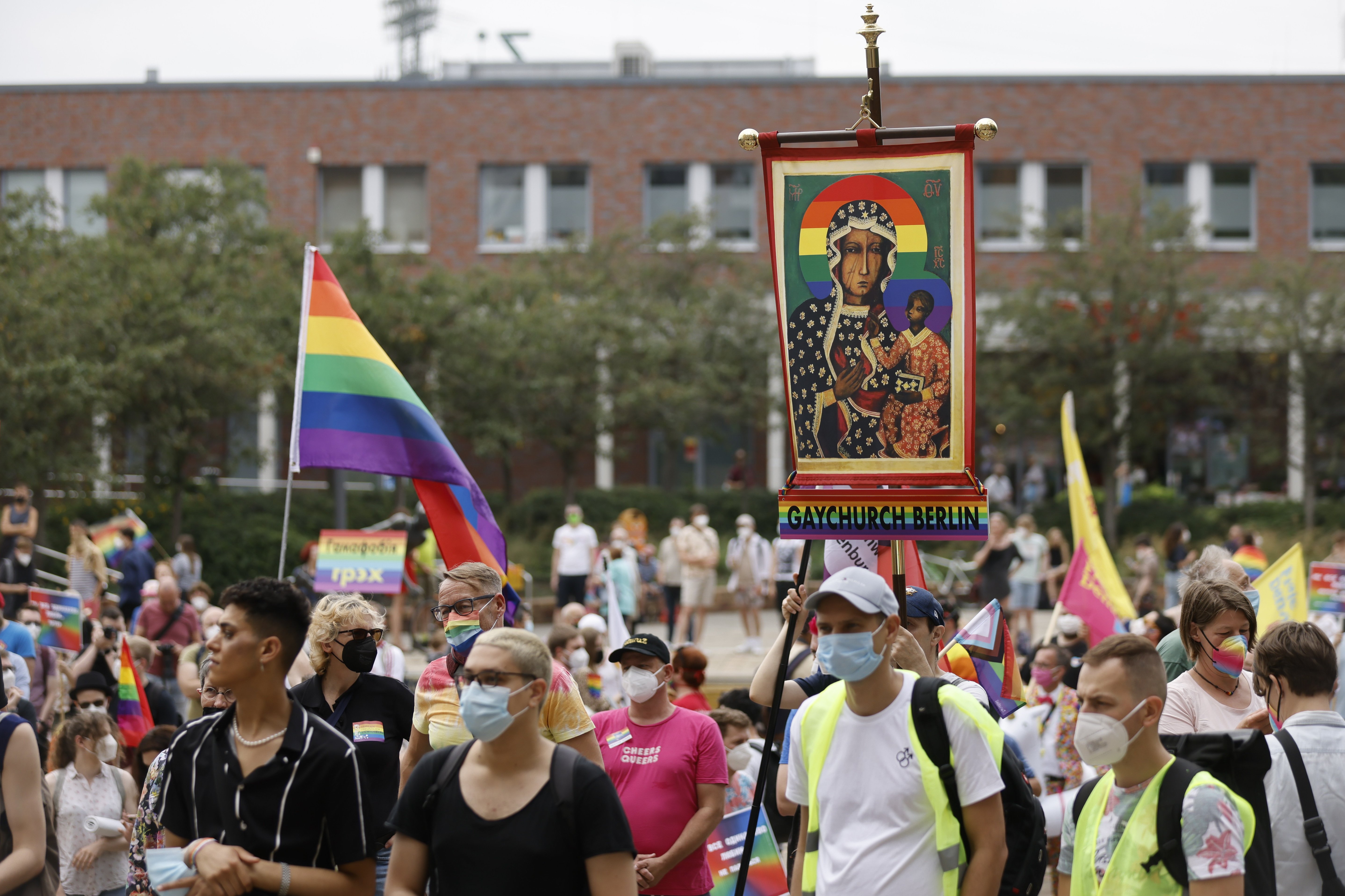 Activists carrying a rainbow flag and a banner with an image of Mary and the Christ Child attend the second "Marzahn Pride" march in Berlin July 17, 2021. (CNS photo/Axel Schmidt, Reuters)