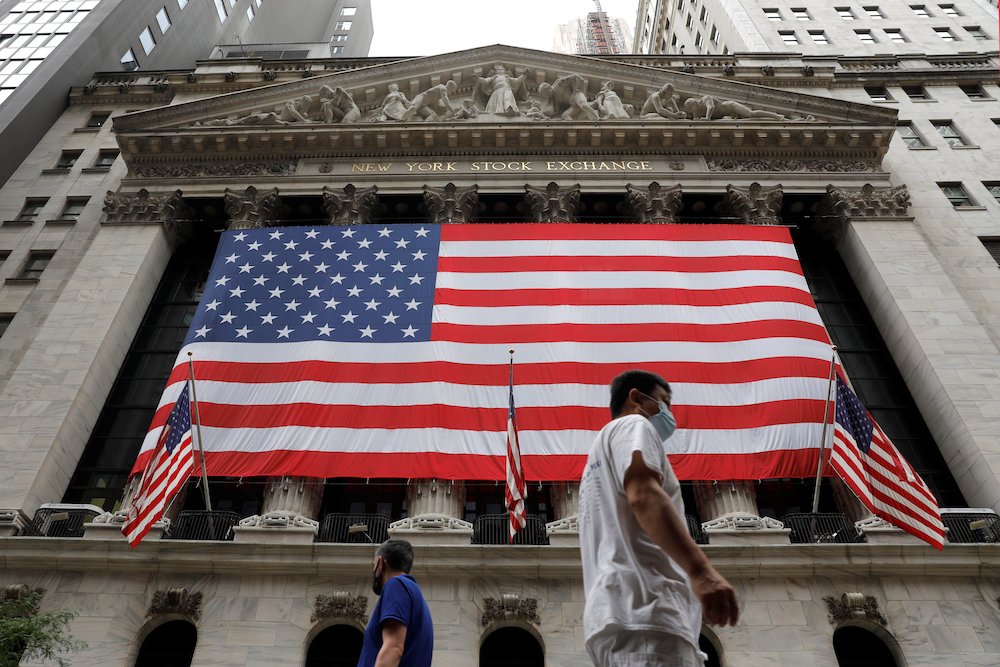 People in New York City walk by American flags Aug. 9. On Aug. 11, the Senate passed a $3.5 trillion spending package that includes immigration reform provisions, including creating a path to citizenship for 10 million people in the U.S. illegally. (CNS)