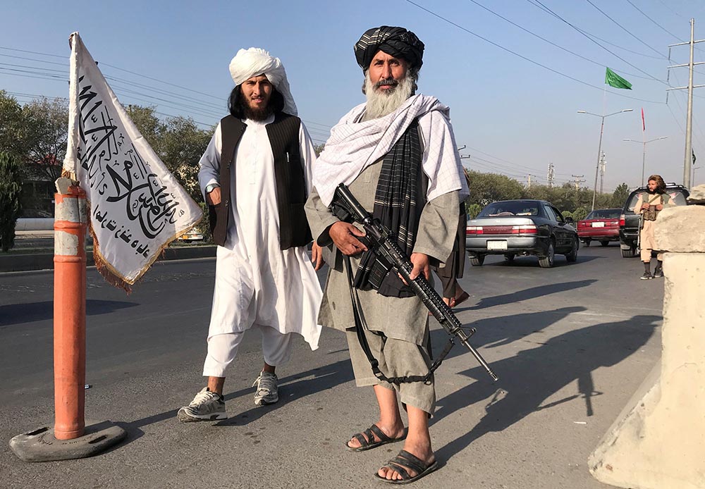 Taliban fighters stand outside the Interior Ministry in Kabul, Afghanistan, Aug. 16. (CNS/Reuters)