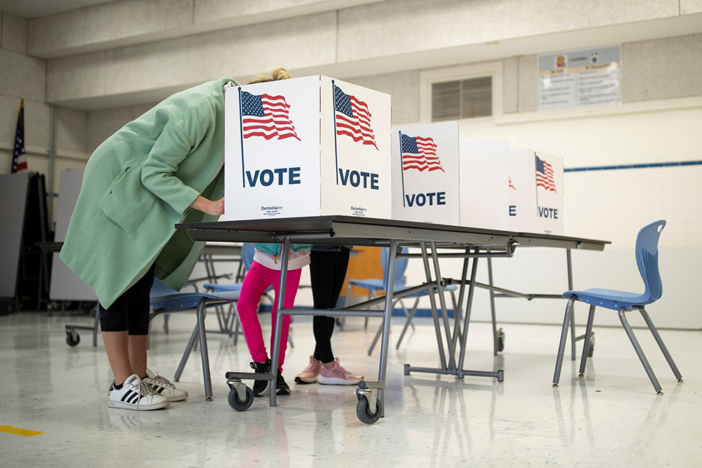 A mother in McLean, Virginia, casts her vote during the governor's race Nov. 2. (CNS/Reuters/Tom Brenner)