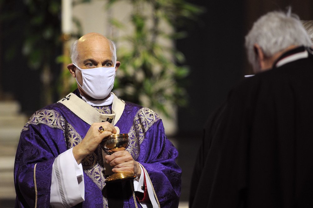 San Francisco Archbishop Salvatore Cordileone distributes Communion during a Mass for the homeless Nov. 6 at the Cathedral of St. Mary of the Assumption. (CNS photo/David Maung)