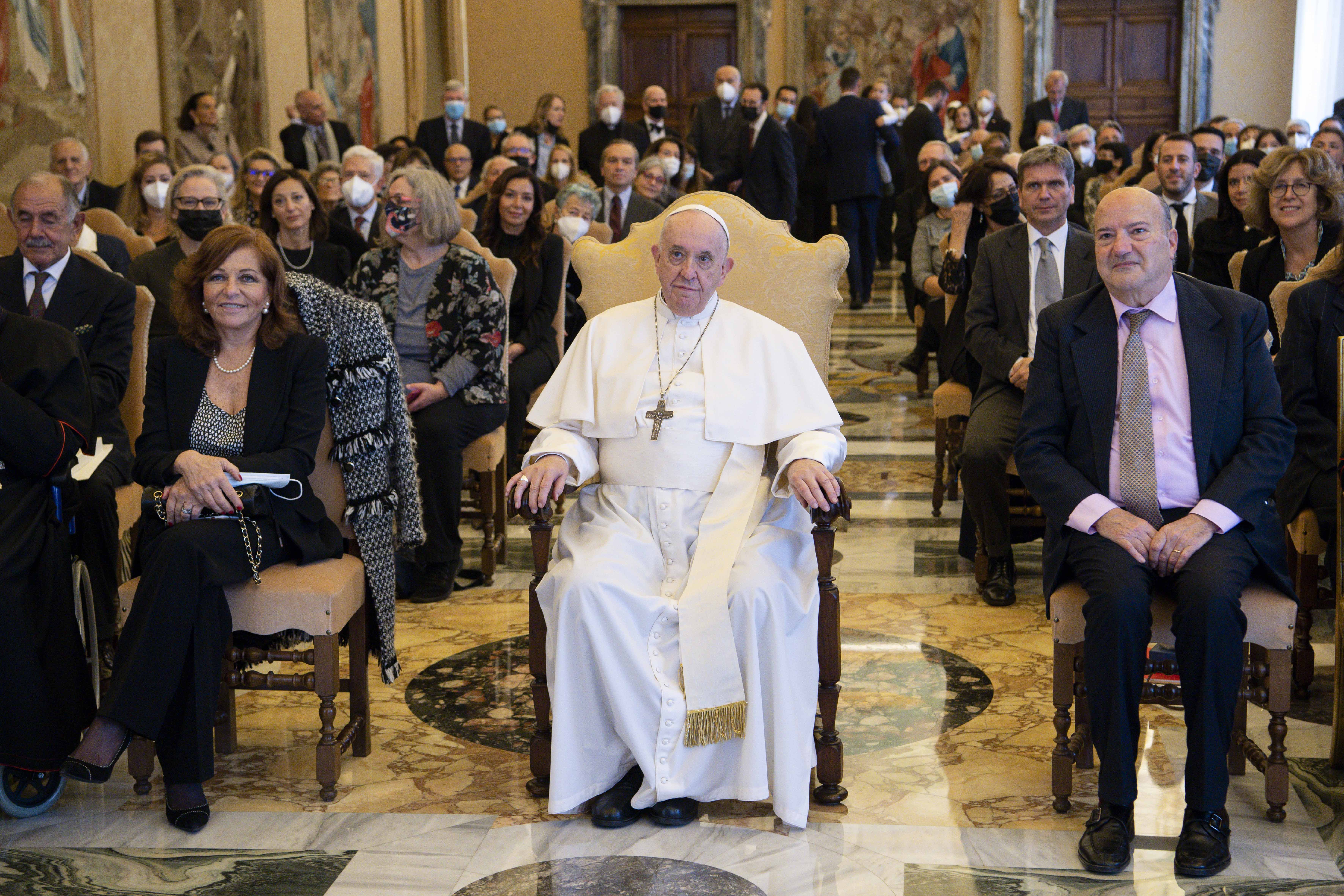 Pope Francis is seated next to Valentina Alazrak of Televisa and Philip Pullella of Reuters during a ceremony to honor the two journalists in the Apostolic Palace at the Vatican Oct. 13, 2021. (CNS photo/Vatican Media)