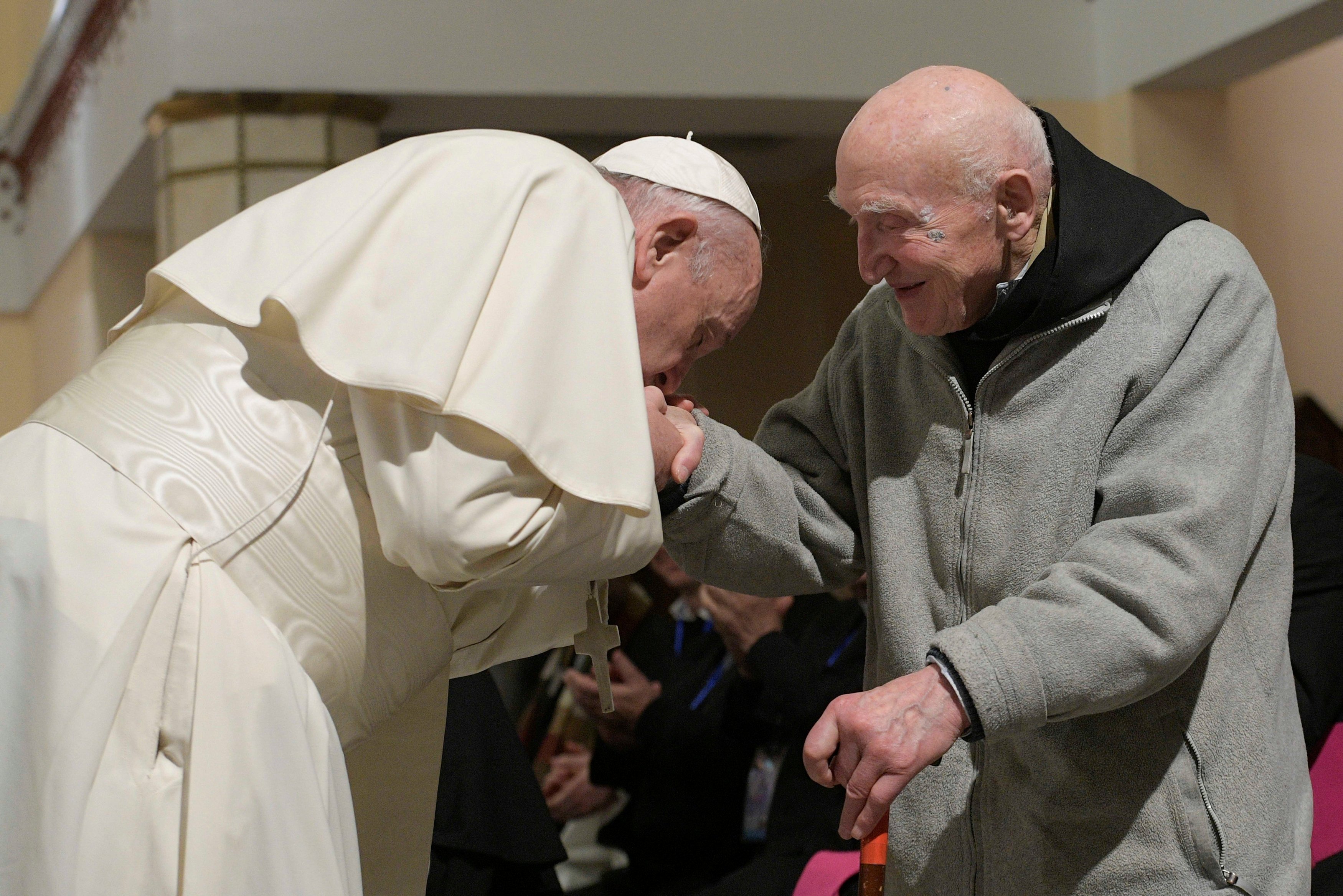 In this photo Pope Francis kisses Father Schumacher's hand during a meeting at the cathedral in Rabat, Morocco, March 31, 2019. (CNS photo/Vatican Media)