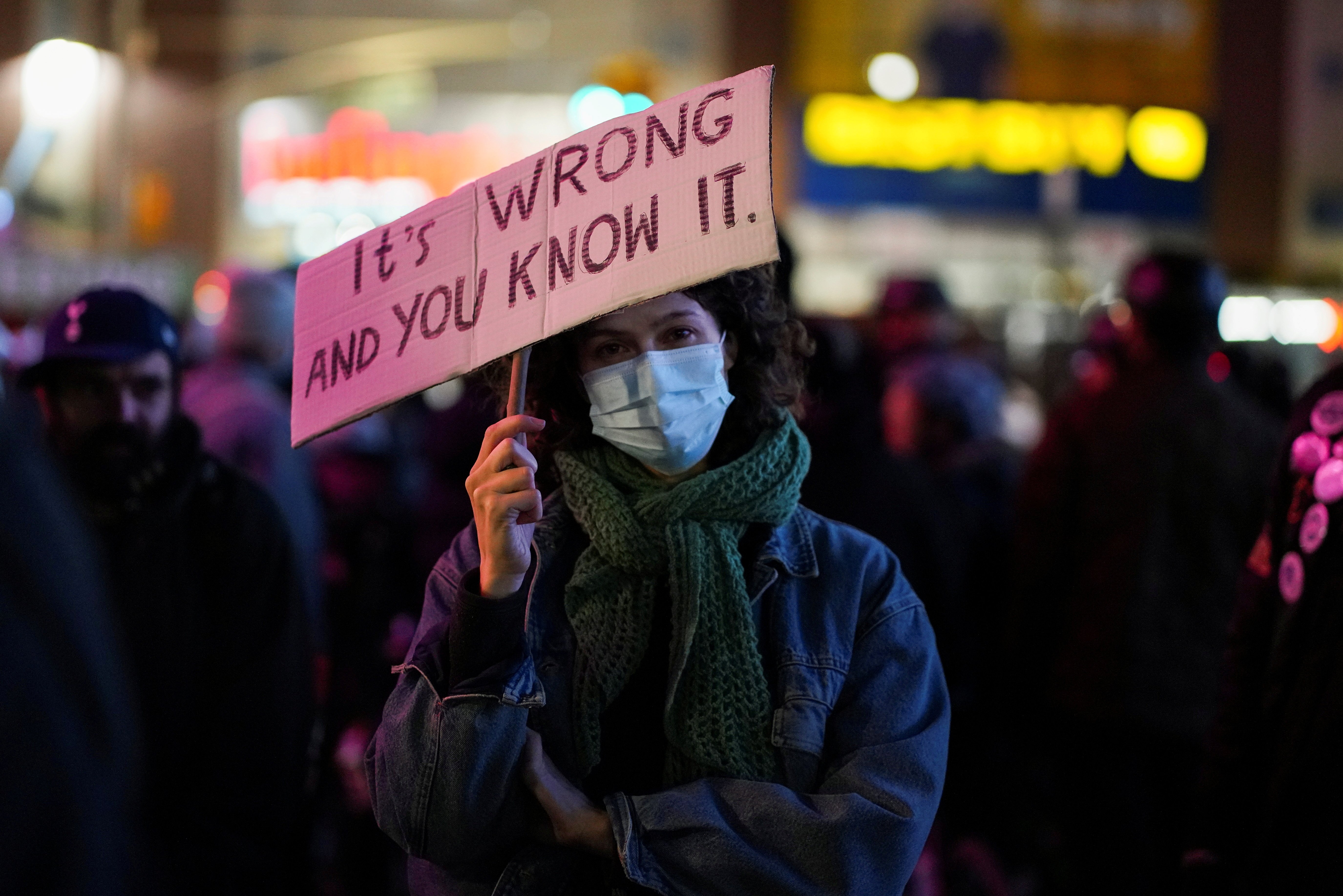 A demonstrator in New York City holds a placard during a protest Nov. 19 after Kyle Rittenhouse was acquitted by a jury that day in the shooting deaths of two people and the wounding of another in 2020. (CNS/Reuters/David Dee Dellgado)