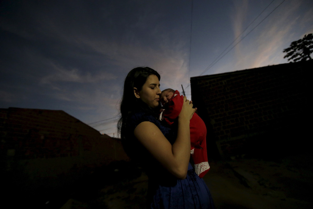 A single mother poses with her child in this 2016 file photo from Brazil.