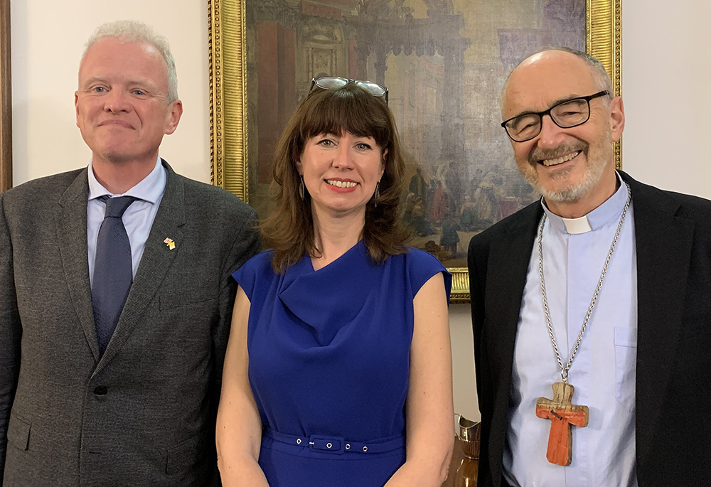 Chris Trott, British ambassador to the Holy See; Anna Rowlands, a professor and author; and Canadian Cardinal Michael Czerny, interim president of the Dicastery for Promoting Integral Human Development, pose March 7, at Trott’s residence in Rome after a discussion of Rowland's book, Towards a Politics of Communion. (CNS/Cindy Wooden)