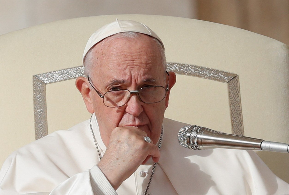 Pope Francis rests his hand on his chin