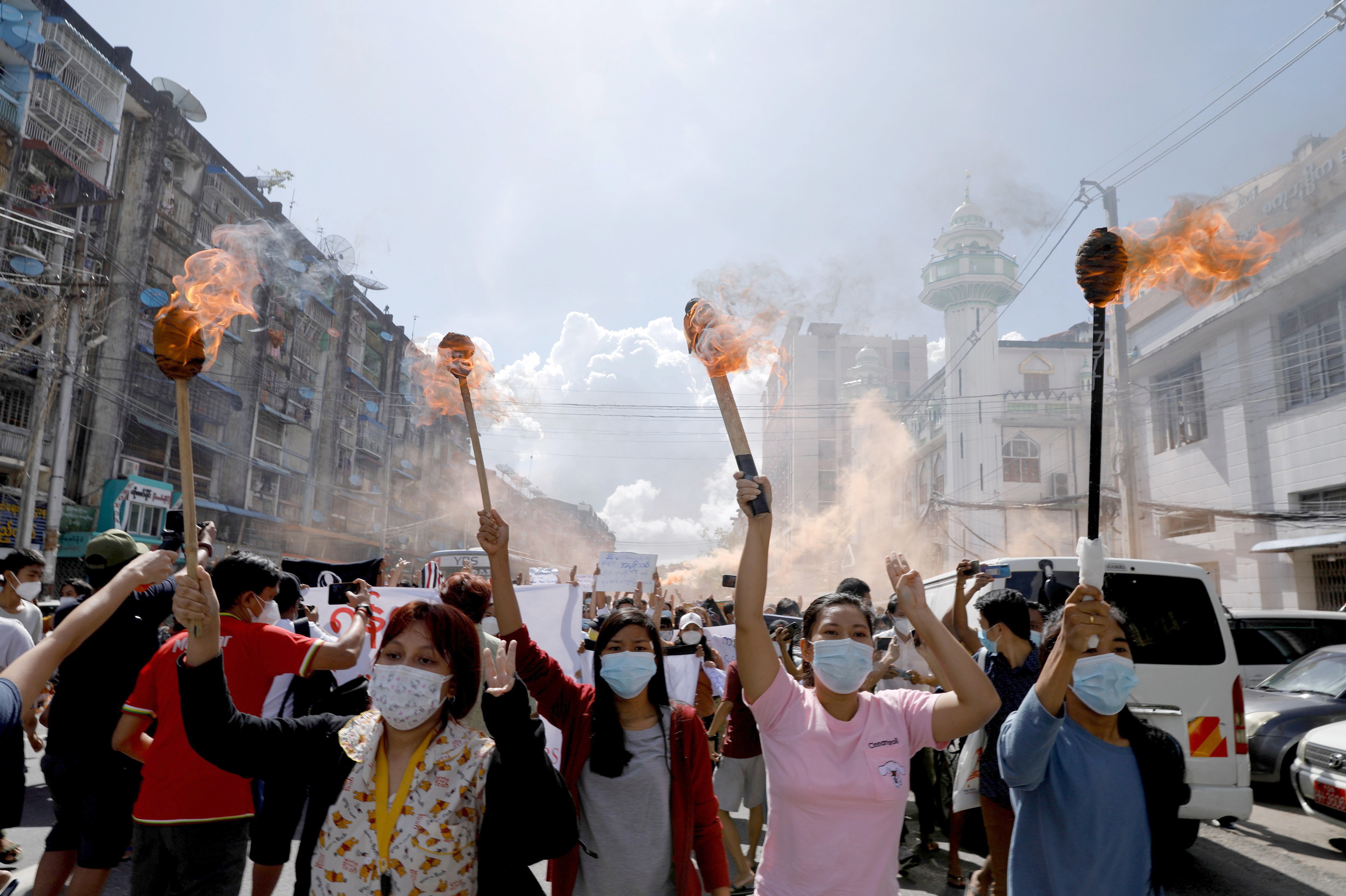 A group of women hold torches as they protest against the military coup in Yangon, Myanmar, July 14, 2021. (CNS photo/Reuters)