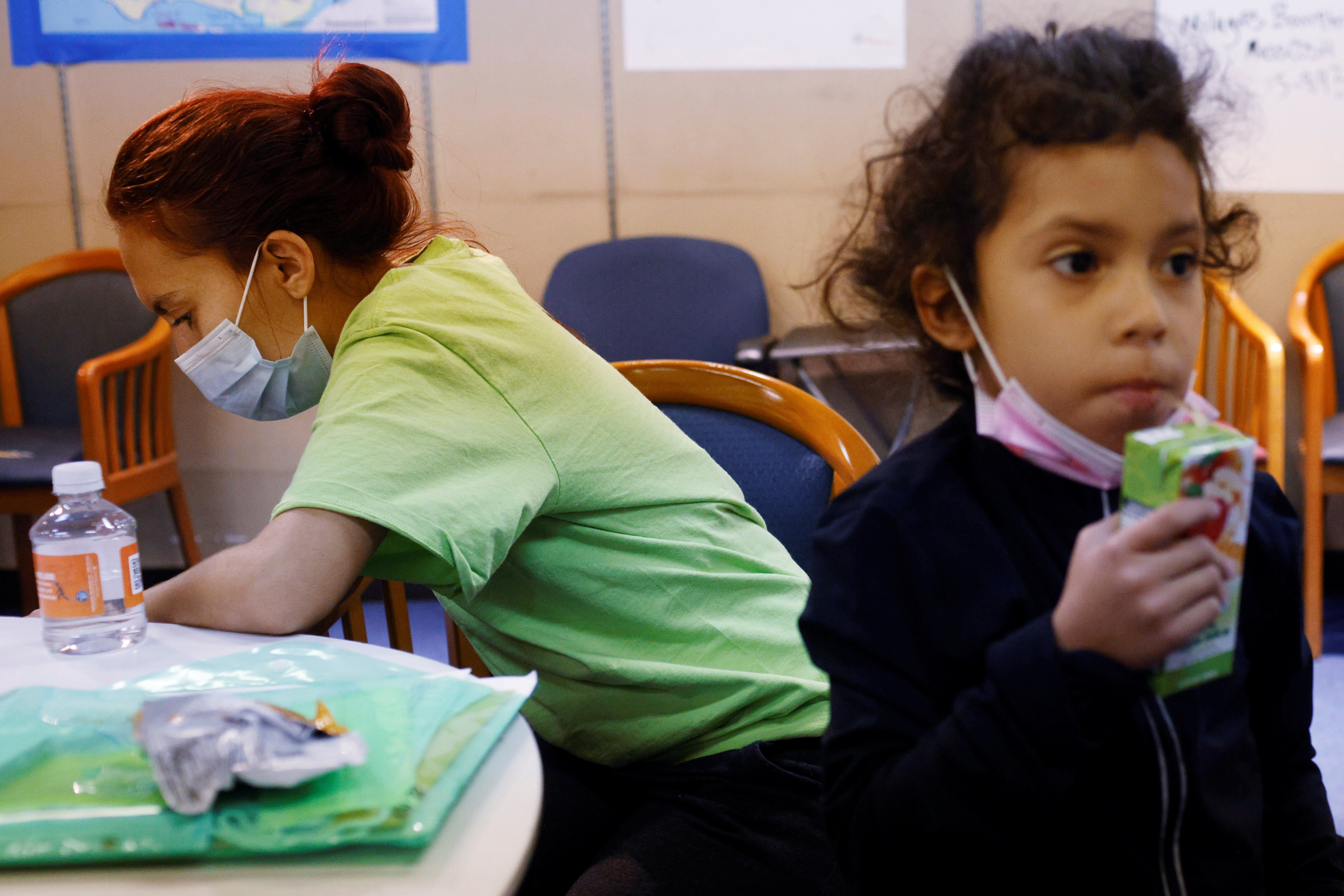 A mother and daughter from Honduras wait at La Colaborativa in Chelsea, Mass., Sept. 30, 2021, while getting help with free clothes and food as well as advice for their upcoming immigration hearing. (CNS photo/Brian Snyder, Reuters)