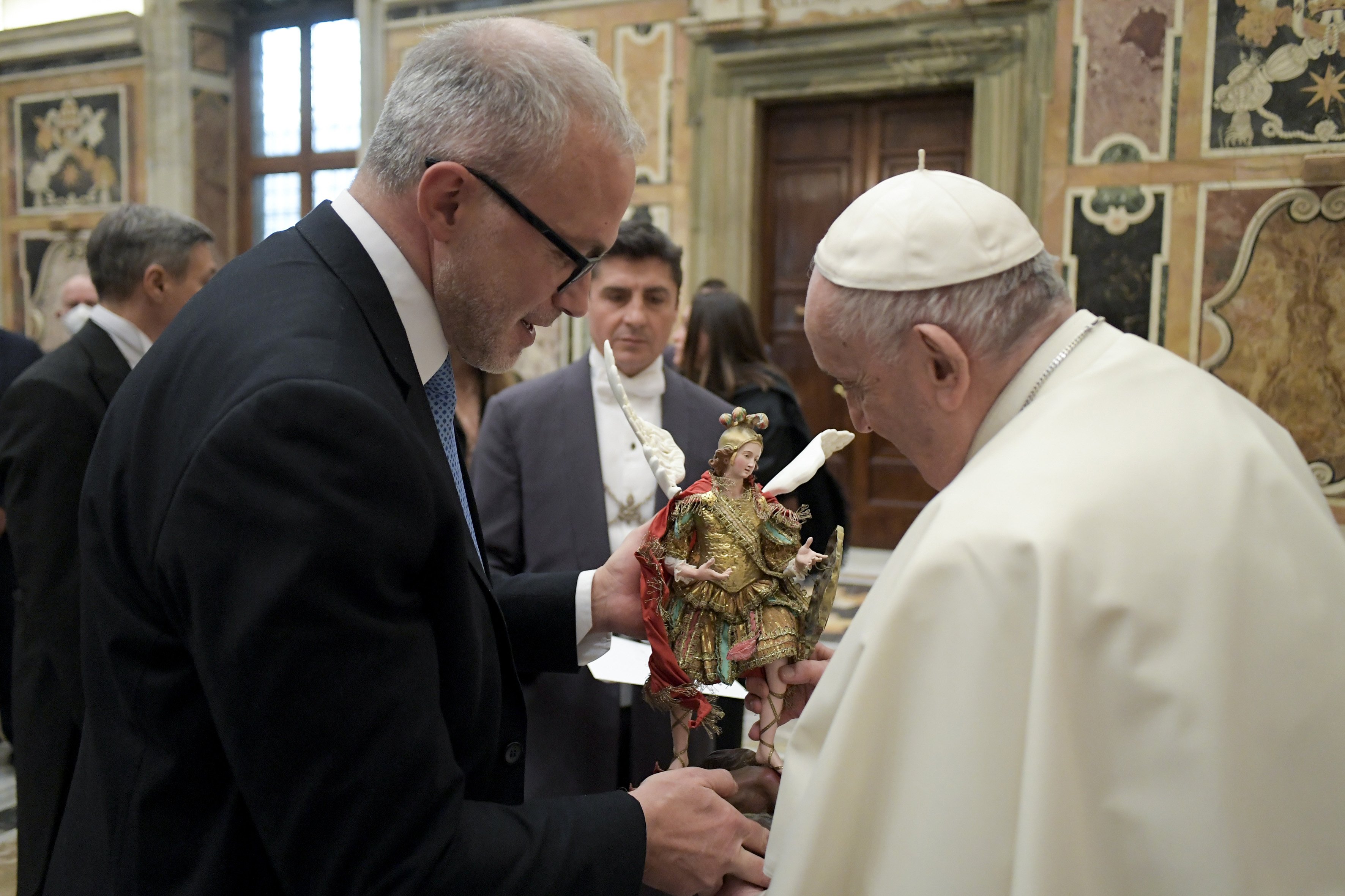 Pope Francis accepts a gift during an audience with a delegation from the Agenzia delle Entrate, Italy's governmental tax agency, at the Vatican Jan. 31, 2022.(CNS photo/Vatican Media)