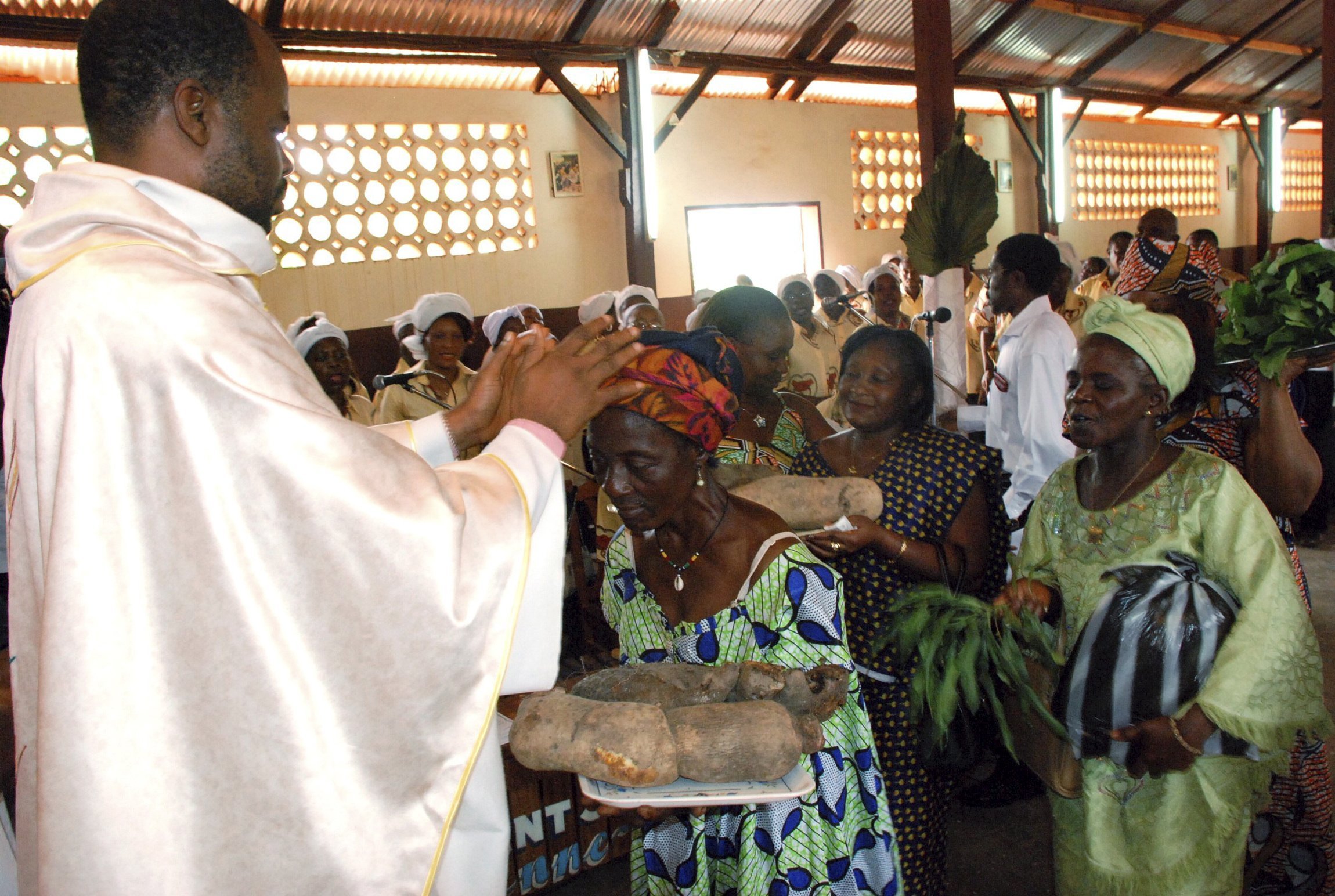 A priest is pictured in a file photo accepting offertory gifts during Mass at St. Therese of the Child Jesus Catholic Church in Yaounde, Cameroon. (CNS photo/Saabi, Galbe.Com)