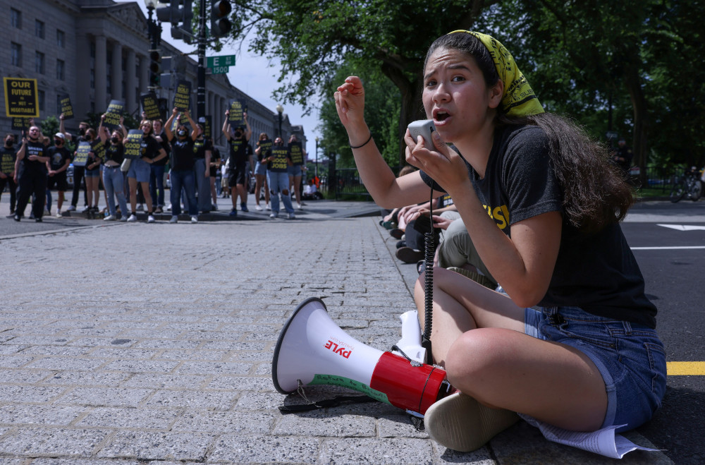 Activists protesting climate change and pushing for green jobs are seen near the White House in Washington June 4, 2021. (CNS/Reuters/Evelyn Hockstein)