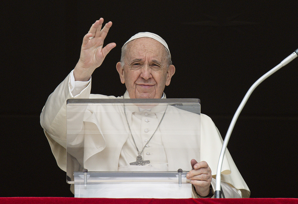 Pope Francis greets the crowd as he leads the Angelus from the window of his studio overlooking St. Peter's Square March 27 at the Vatican. (CNS/Vatican Media)