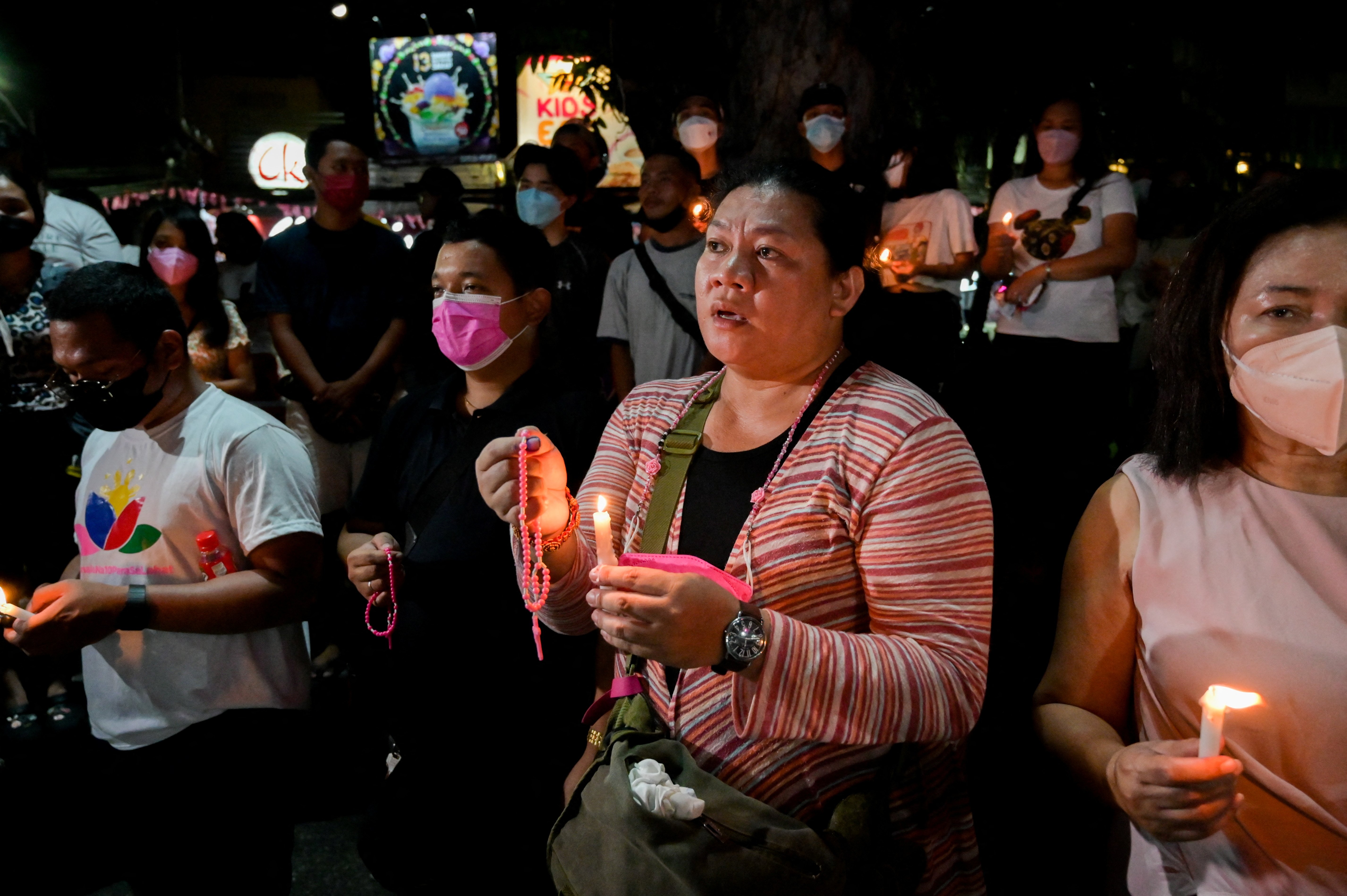 Supporters of Vice President Leonor "Leni" Robredo pray during a candlelight vigil at Plaza Quince Martires in Naga May 9, 2022. (CNS photo/Lisa Marie David, Reuters)