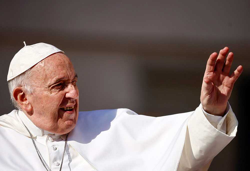 Pope Francis greets people as he arrives for his general audience in St. Peter's Square June 15 at the Vatican. (CNS/Reuters/Yara Nardi)