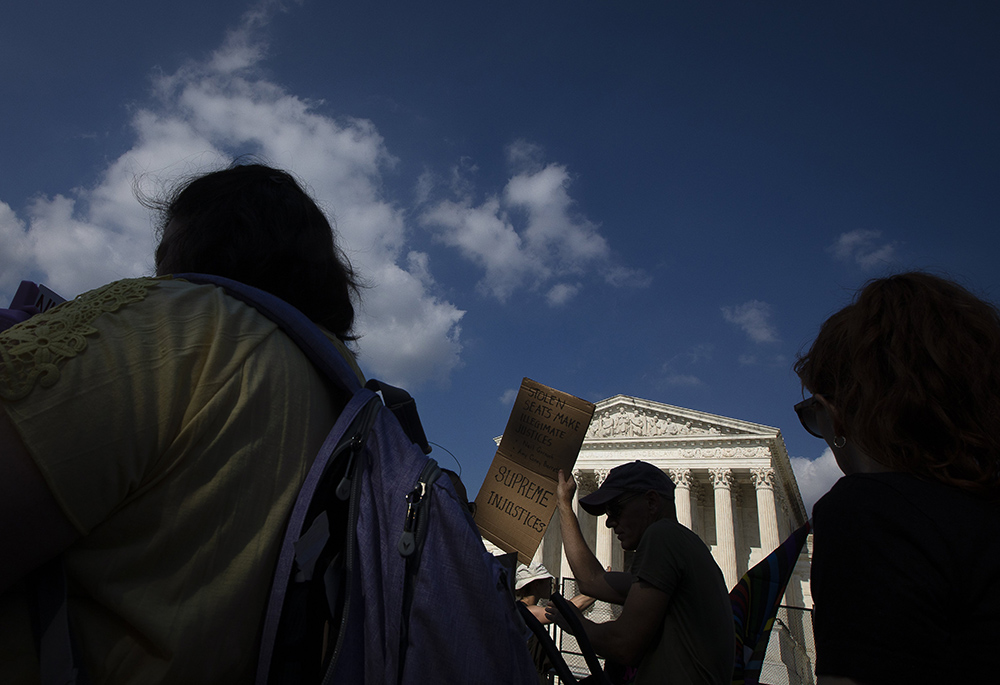 Abortion demonstrators are seen near the Supreme Court June 24 in Washington, as the court overruled the landmark Roe v. Wade abortion decision in its ruling in the Dobbs case on a Mississippi law banning most abortions after 15 weeks. (CNS/Tyler Orsburn)