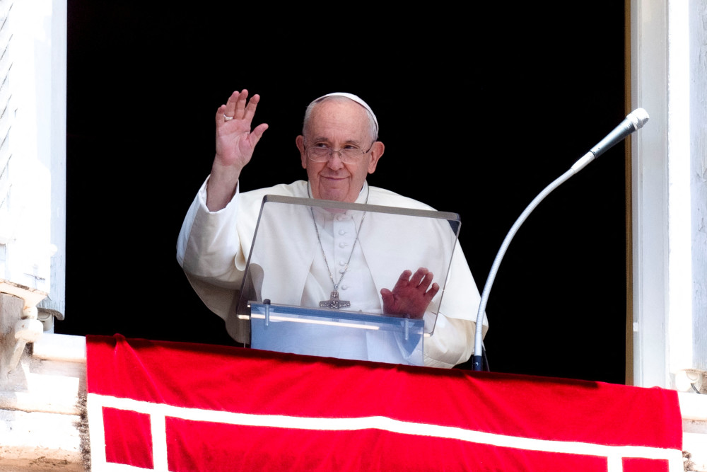 Pope Francis greets the crowd as he leads the Angelus from the window of his studio overlooking St. Peter's Square at the Vatican July 31, 2022. (CNS photo/Vatican Media via Reuters)