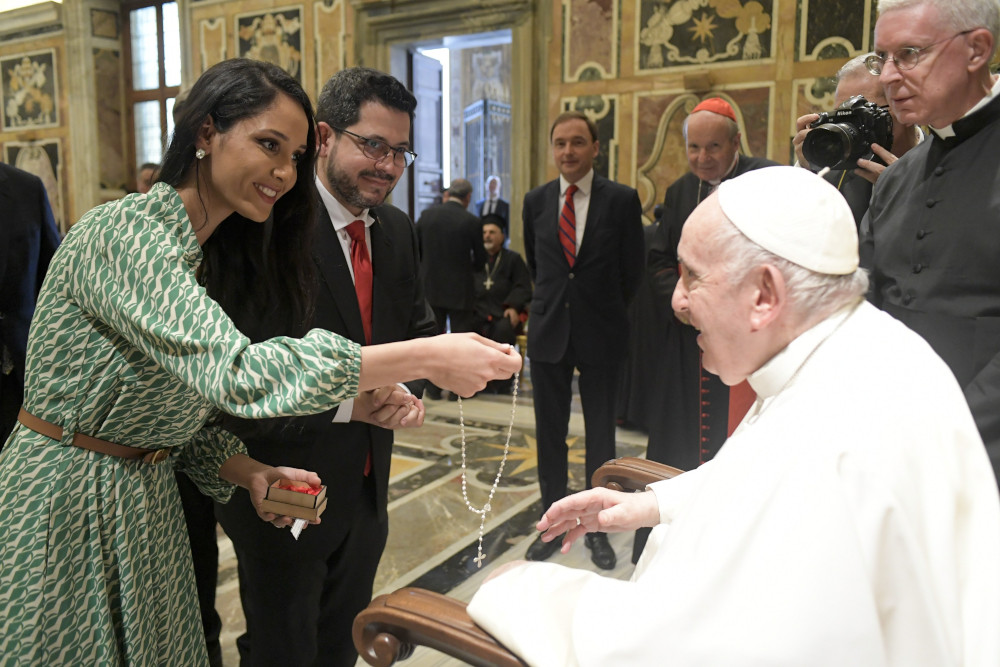 Pope Francis accepts a rosary during an audience with members of the International Catholic Legislators Network at the Vatican Aug. 25, 2022. (CNS photo/Vatican Media)