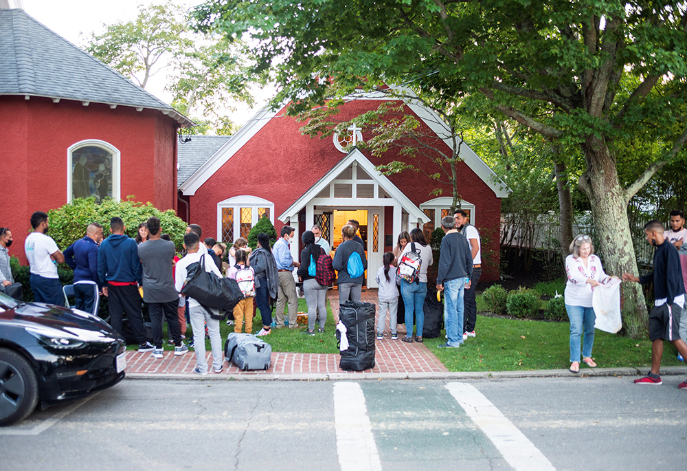 Venezuelan migrants stand outside St. Andrew's Episcopal Church Sept 14 in Edgartown, Massachusetts, on Martha's Vineyard. (CNS/Vineyard Gazette via Reuters/Ray Ewing)