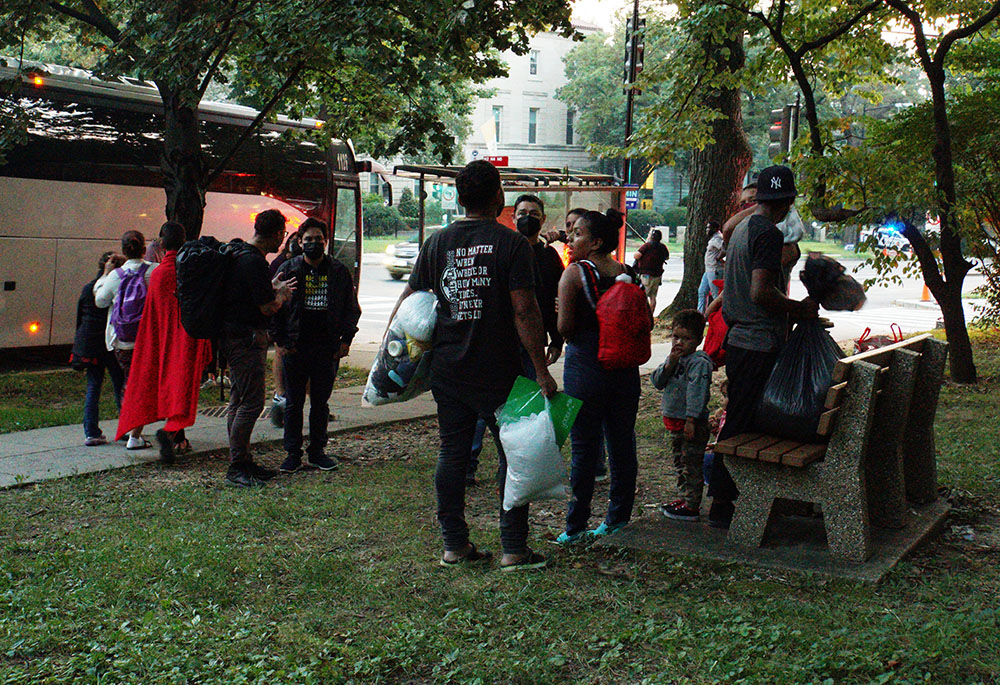 A group of mainly Venezuelan migrants sent by bus to Washington from detention in Texas are dropped off Sept. 17 outside the Naval Observatory, the official residence of Vice President Kamala Harris. (CNS/Reuters/Marat Sadana)