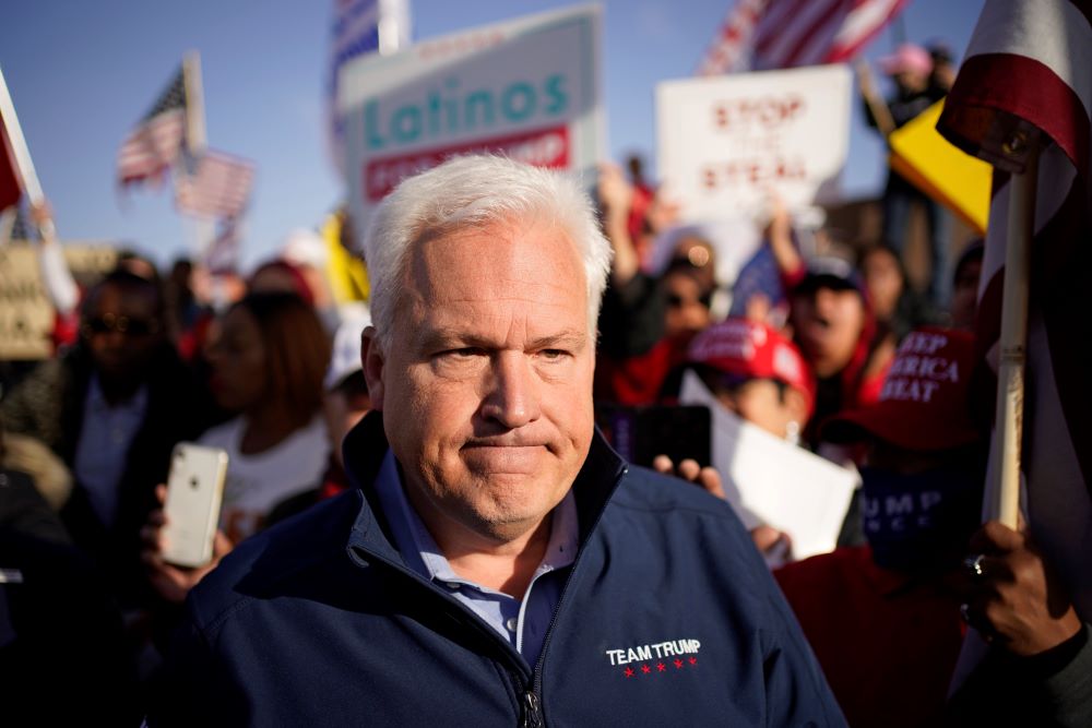 Matt Schlapp with election signs behind him.