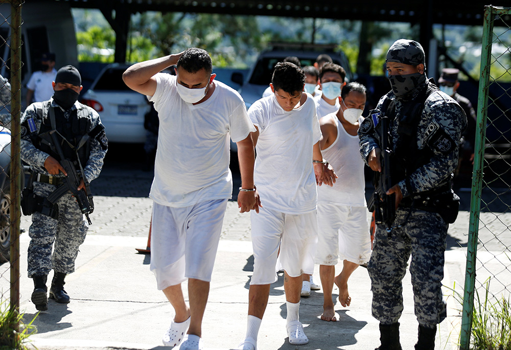 Suspected gang members are presented to the media Nov. 28, 2020, in San Salvador, El Salvador, after being arrested by police during a one-week coordinated law enforcement action with other countries under Operation Regional Shield. In March 2022, Salvadoran President Nayib Bukele suspended some constitutional rights to fight crime, especially gangs. (CNS/Reuters/Jose Cabezas)