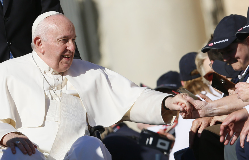 Pope Francis greets people during his general audience in St. Peter's Square at the Vatican Oct. 5, 2022. Vatican News March 10, 2023, published excerpts of a new interview with RSI, a Swiss radio-television broadcasting in Italian, marking his 10 years as pope. (CNS photo/Paul Haring)