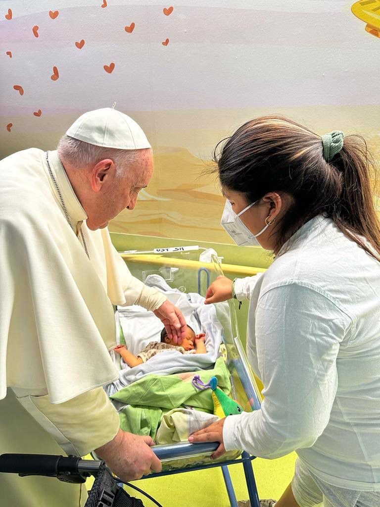 Pope Francis comforts Miguel Angel after baptizing the baby boy in Rome's Gemelli hospital March 31, 2023. The pope spent about half an hour in the hospital's pediatric oncology ward the afternoon before he was scheduled to be released from Gemelli after being treated for bronchitis. (CNS photo/Holy See Press Office)