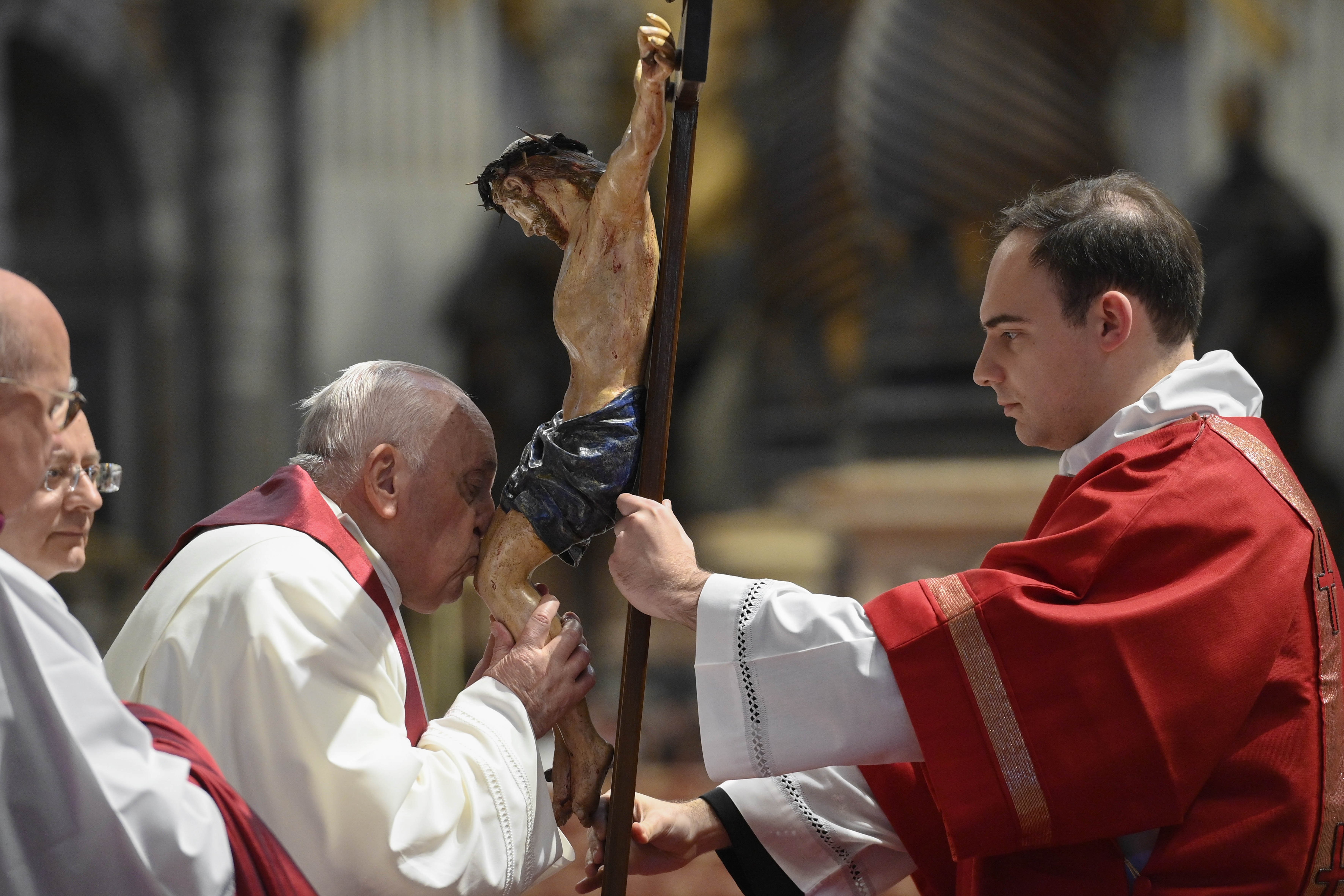 Pope Francis kisses a crucifix during the Good Friday Liturgy of the Lord's Passion in St. Peter's Basilica at the Vatican April 7, 2023. (CNS photo/Vatican Media)