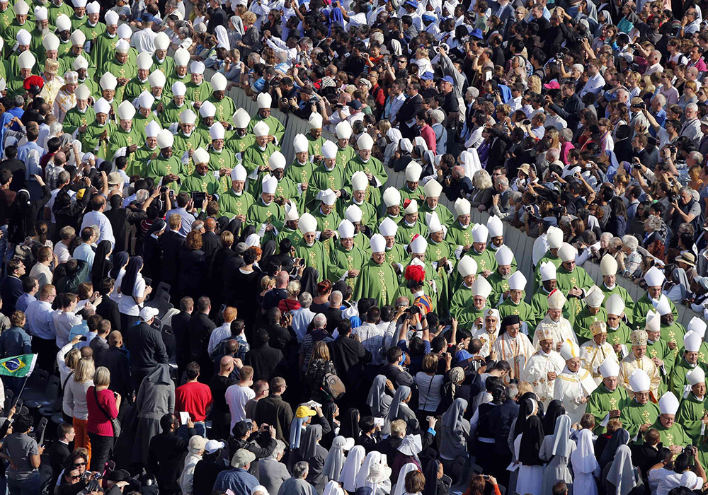 Bishops walk in procession before Pope Benedict XVI celebrates Mass in St. Peter's Square at the Vatican Oct. 11, 2012, to mark the 50th anniversary of the opening of the Second Vatican Council. The Mass also opened the Year of Faith. (CNS/Reuters/Stefano Rellandini)